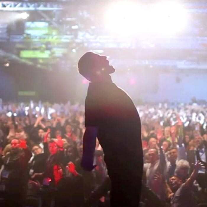 man of power in front of the crowd stage