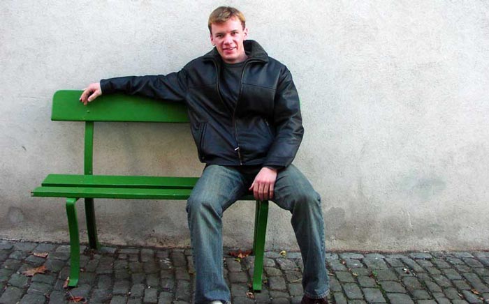 man sitting in open posture
